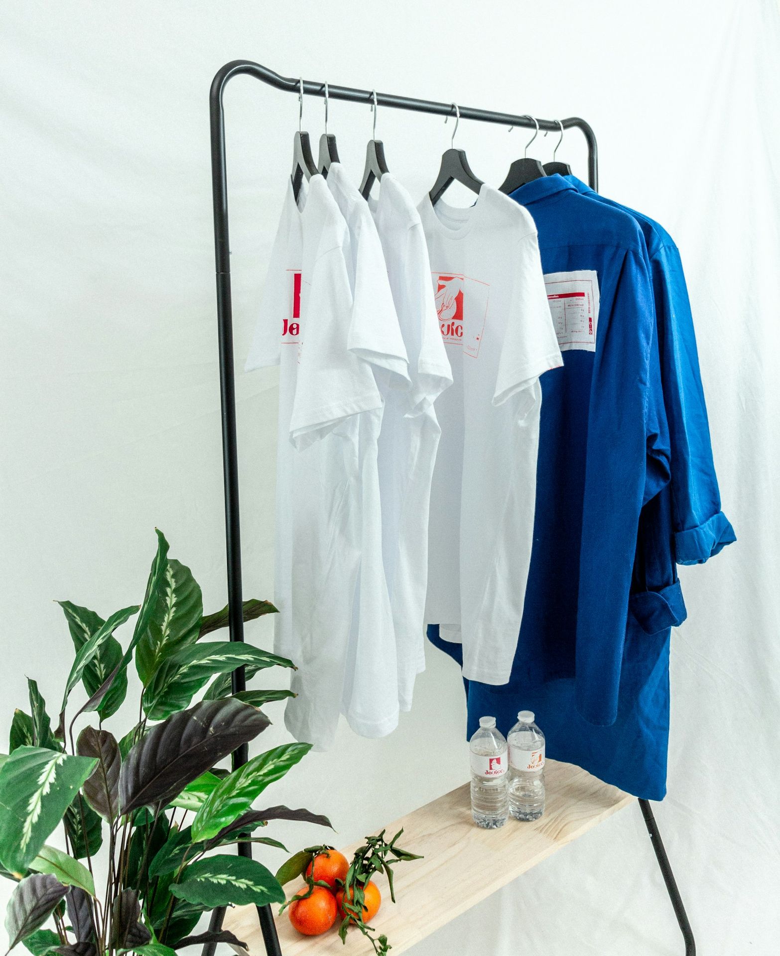 white button up shirt hanging on black metal rack